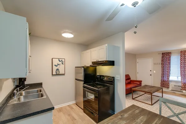 a kitchen with a refrigerator stove and sink