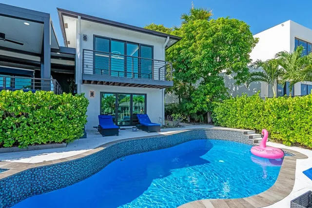 an aerial view of a house with a lake view