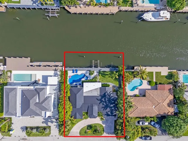 a bedroom with a large bed and a large window