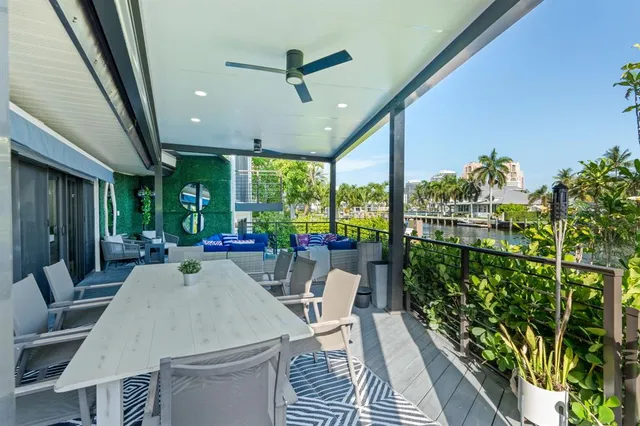a view of a house with backyard and sitting area