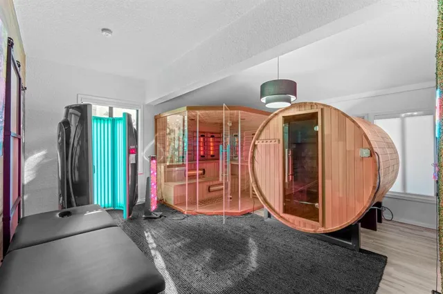 a view of a patio with table and chairs potted plants and floor to ceiling window and potted plants