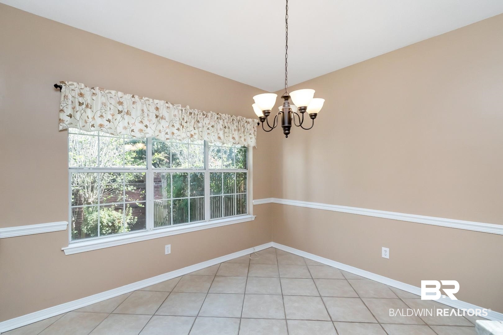6117 Lennox Place Mobile, AL 36693 - Photo 23 of 39 Spare room featuring baseboards, a chandelier, and light tile patterned floors