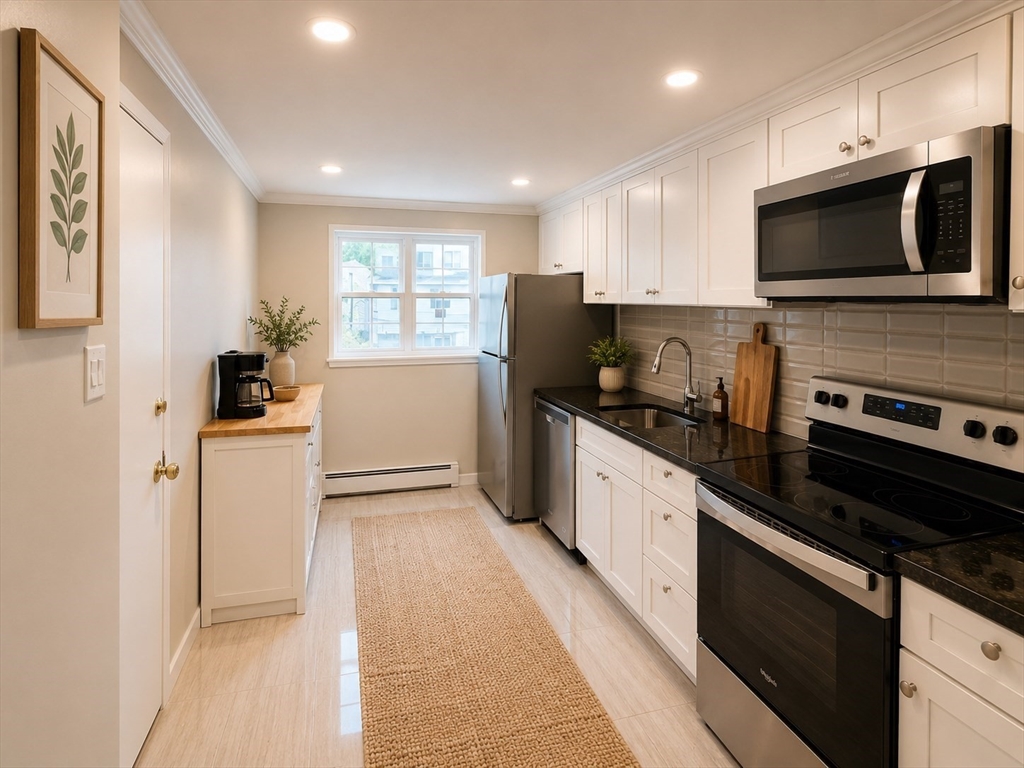 43 Colborne Road, Unit 4 Boston, MA 02135 - Photo 4 of 11 a kitchen with a sink stainless steel appliances and cabinets