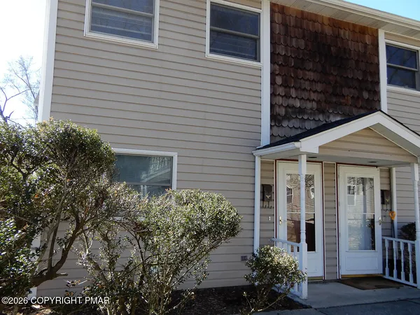 a view of a house with potted plants