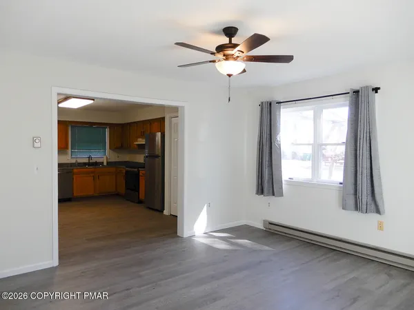 a view of an empty room with a kitchen