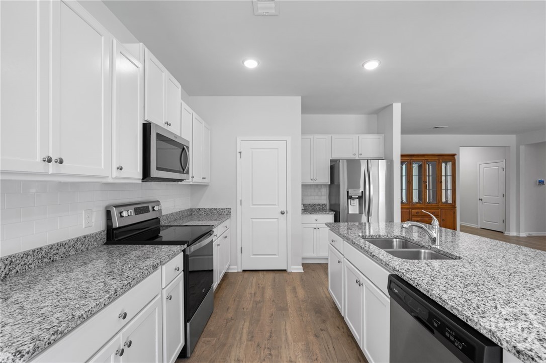 212 Sagefield Drive Rincon, GA 31326 - Photo 16 of 45 Beautiful black/white granite countertops in the kitchen