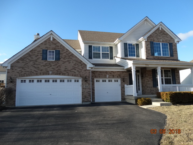 314 Monument Road Elgin, IL 60124 - Photo 1 of 16 a front view of a house with a yard