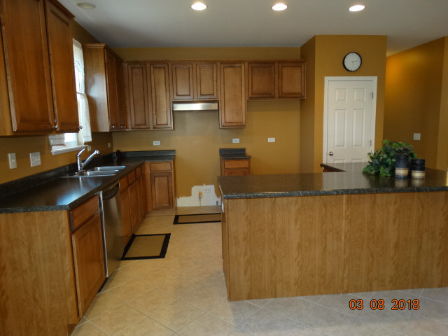 314 Monument Road Elgin, IL 60124 - Photo 2 of 16 a kitchen with granite countertop a sink a stove and a refrigerator