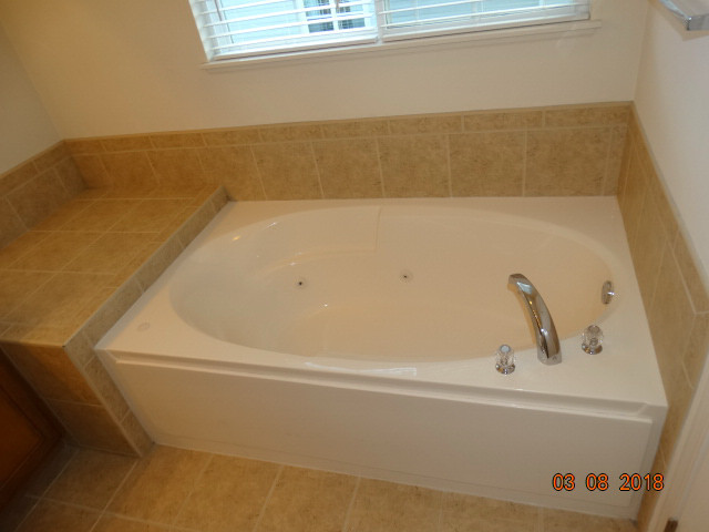 314 Monument Road Elgin, IL 60124 - Photo 10 of 16 a bath tub sitting next to a bathroom
