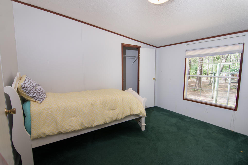 423 Tedder Road East DeFuniak Springs, FL 32433 - Photo 12 of 29 a bed sitting in a bedroom next to a window