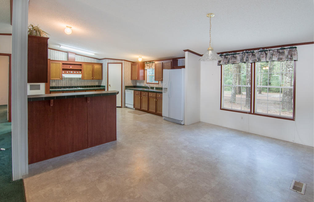 423 Tedder Road East DeFuniak Springs, FL 32433 - Photo 13 of 29 a open kitchen with stainless steel appliances granite countertop a refrigerator and a stove top oven