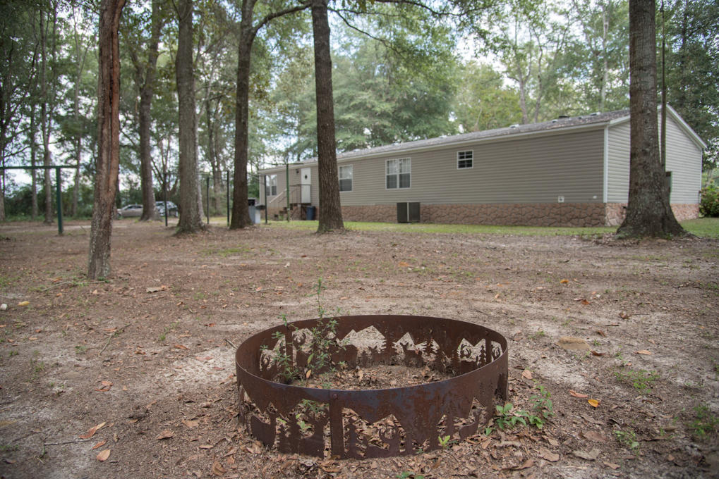 423 Tedder Road East DeFuniak Springs, FL 32433 - Photo 15 of 29 a view of a backyard with large trees