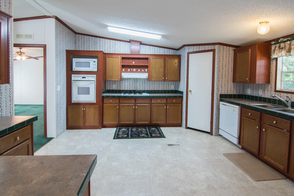 423 Tedder Road East DeFuniak Springs, FL 32433 - Photo 16 of 29 a kitchen with stainless steel appliances granite countertop a refrigerator and stove
