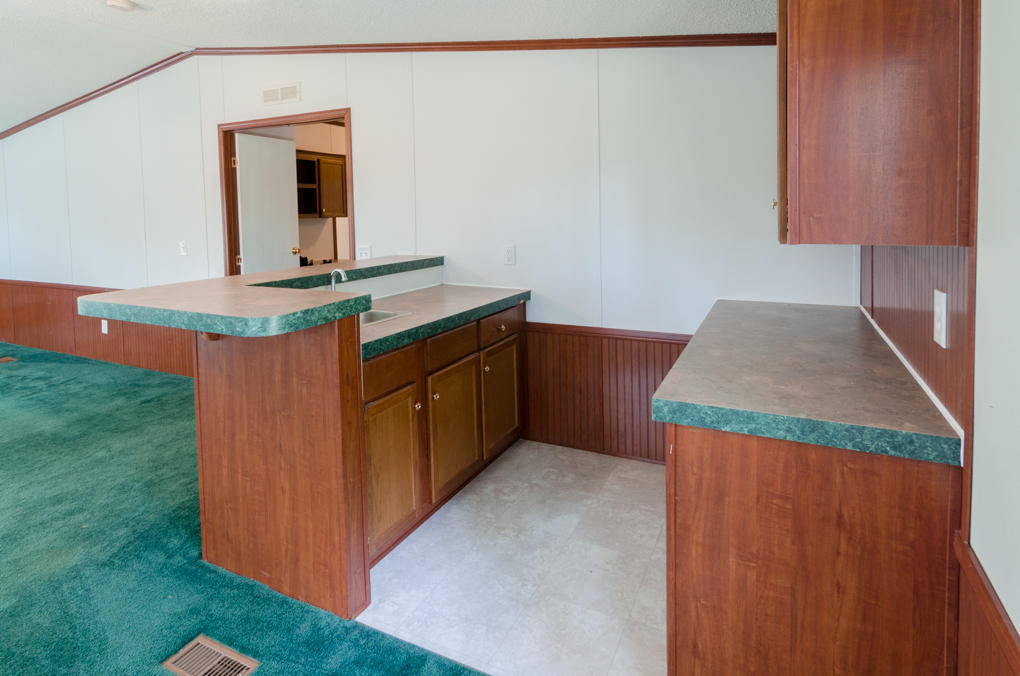 423 Tedder Road East DeFuniak Springs, FL 32433 - Photo 9 of 29 a kitchen with kitchen island a sink and a stove