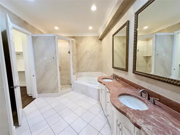 a bathroom with a granite countertop sink mirror vanity and toilet