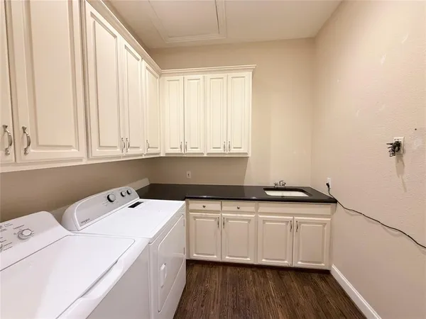 a utility room with sink dryer and washer