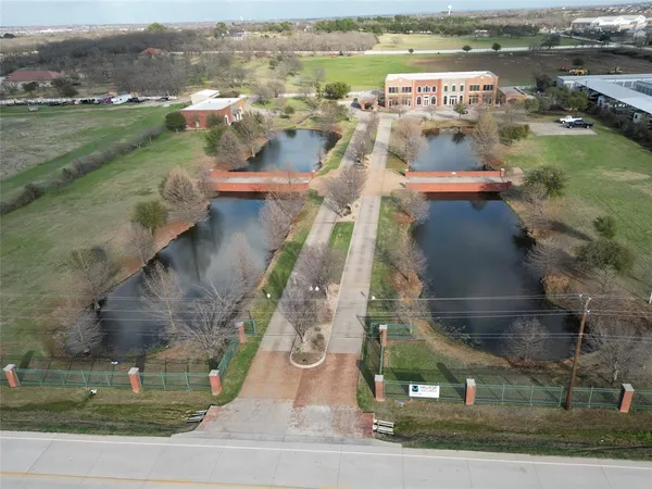 an aerial view of residential houses with outdoor space and parking