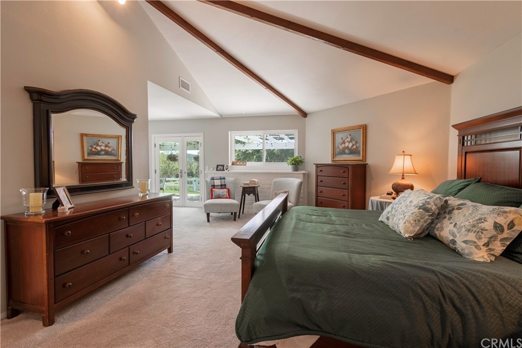 2755 Ardilla Road Atascadero, CA 93422 - Photo 20 of 42 a bedroom with a large bed and a flat tv screen on dresser