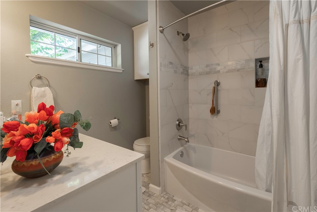 2755 Ardilla Road Atascadero, CA 93422 - Photo 21 of 42 a bathroom with a tub sink mirror and a bathtub with shower