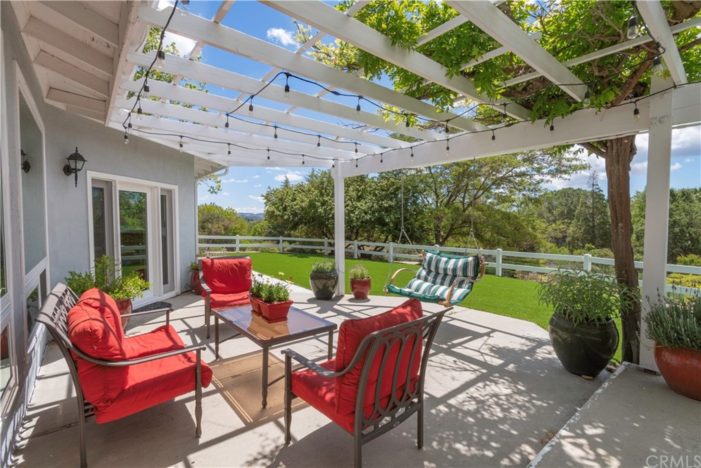 2755 Ardilla Road Atascadero, CA 93422 - Photo 29 of 42 a view of a patio with a table chairs and a backyard