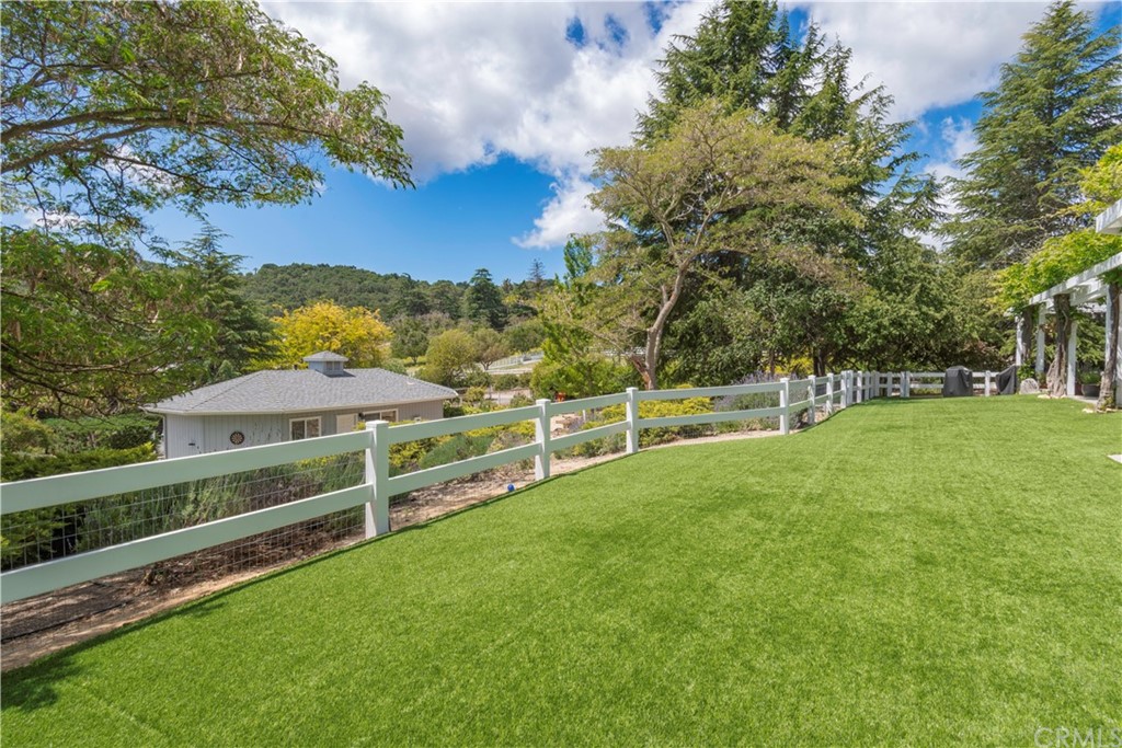 2755 Ardilla Road Atascadero, CA 93422 - Photo 31 of 42 a view of a garden with a bench and trees