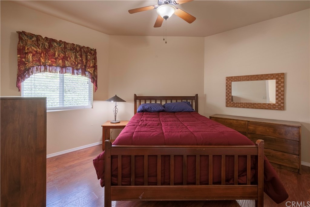 2755 Ardilla Road Atascadero, CA 93422 - Photo 36 of 42 a bedroom with a bed window and a chandelier