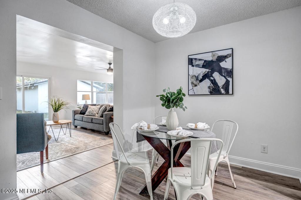 1050 Glynlea Road Jacksonville, FL 32216 - Photo 11 of 38 a dining room with furniture and wooden floor