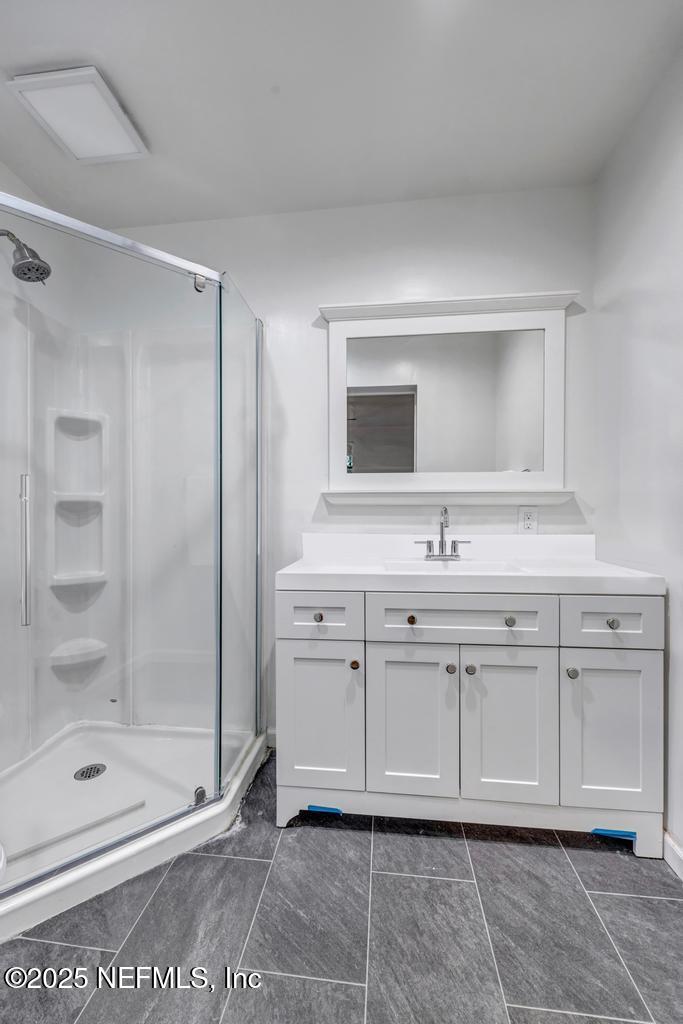 1050 Glynlea Road Jacksonville, FL 32216 - Photo 25 of 38 a bathroom with a shower sink and mirror