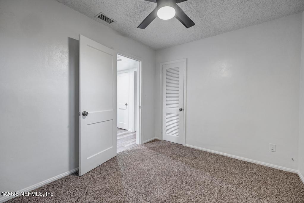 1050 Glynlea Road Jacksonville, FL 32216 - Photo 30 of 38 an empty room with a empty space and windows