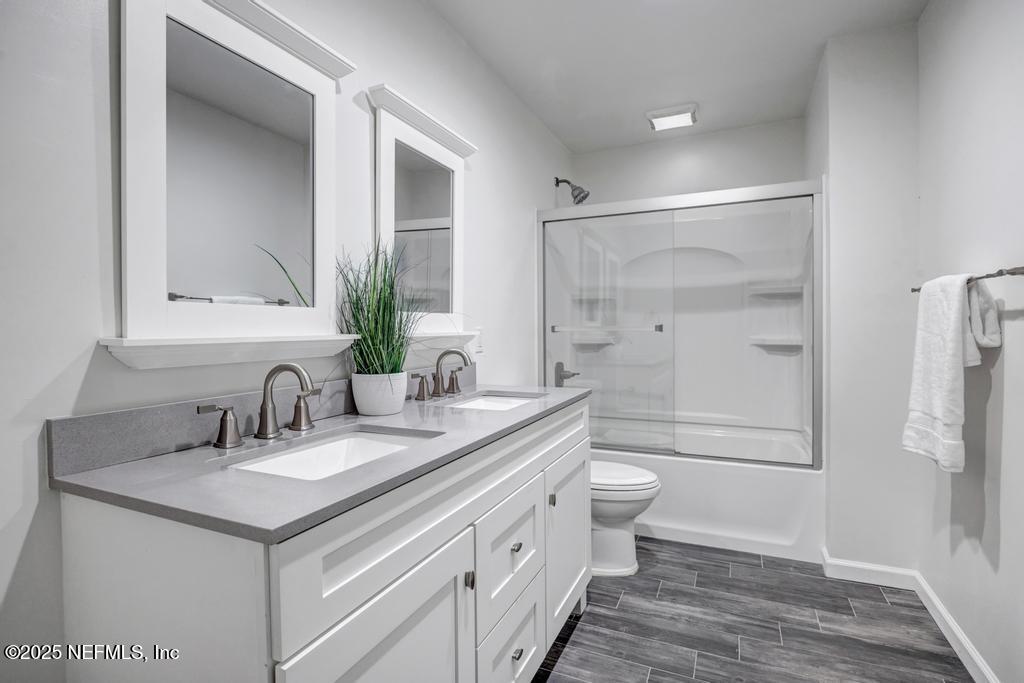 1050 Glynlea Road Jacksonville, FL 32216 - Photo 37 of 38 a bathroom with a double vanity sink toilet and shower