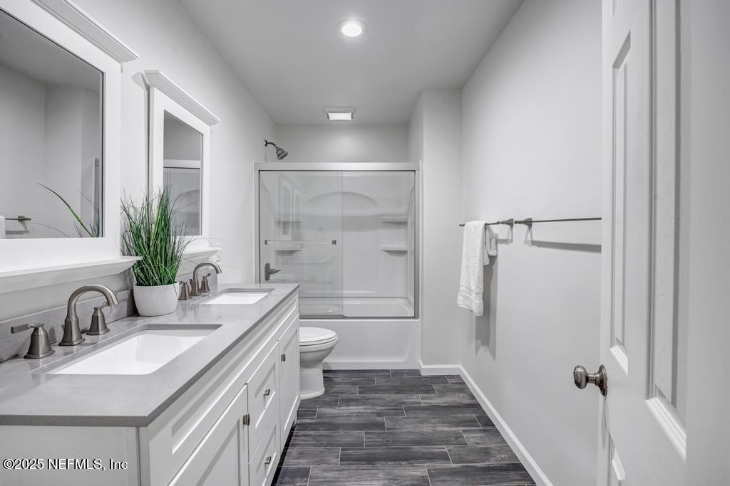 1050 Glynlea Road Jacksonville, FL 32216 - Photo 38 of 38 a bathroom with a double vanity sink a toilet and shower