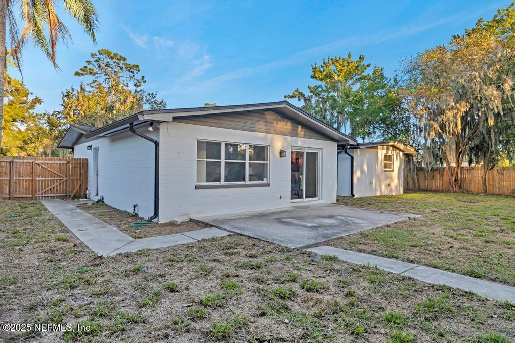 1050 Glynlea Road Jacksonville, FL 32216 - Photo 4 of 38 a view of a house with a yard and garage
