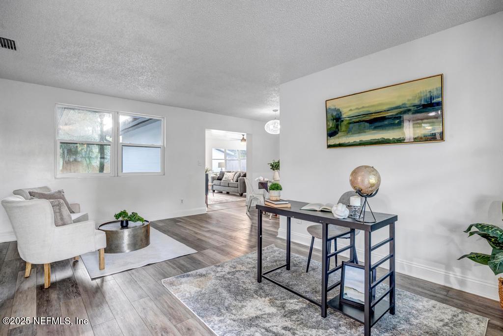 1050 Glynlea Road Jacksonville, FL 32216 - Photo 8 of 38 a living room with furniture and a wooden floor