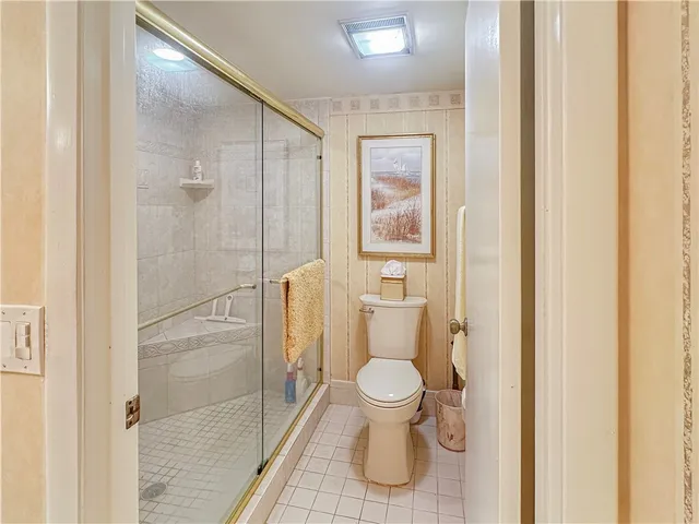 a bathroom with a toilet and a shower