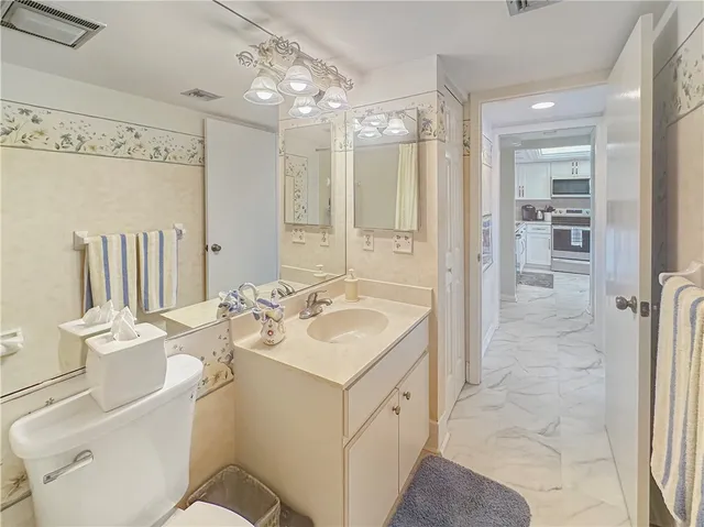 a bathroom with a sink toilet tub and shower