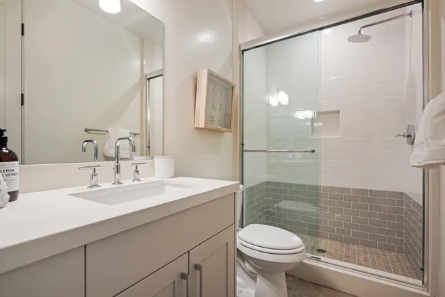 a bathroom with a sink toilet and shower