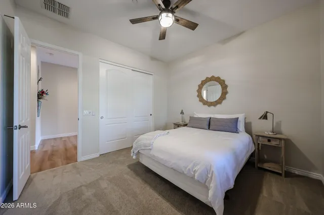 a bedroom with a bed and a chandelier