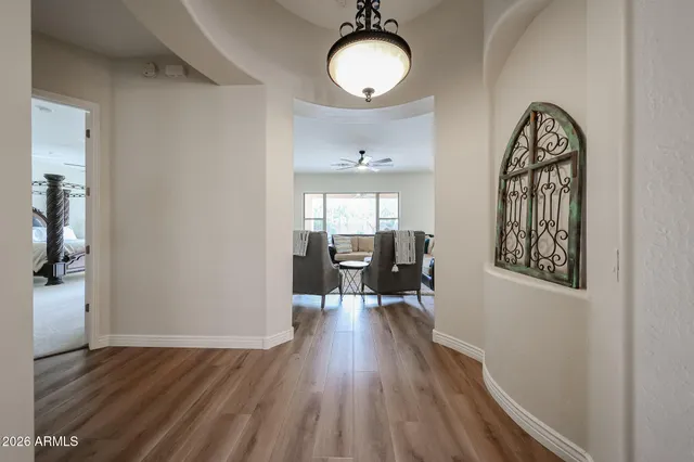a spacious bedroom with a bed and a chandelier
