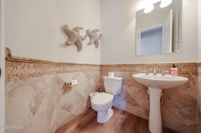 a bedroom with bed and a chandelier