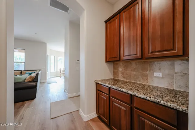 a kitchen with a dining table cabinets stainless steel appliances and a counter top