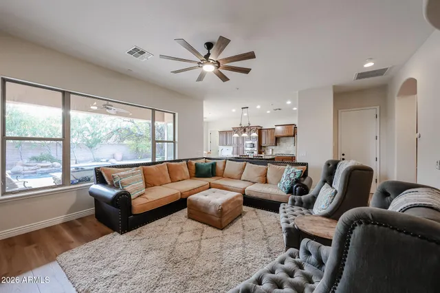 a view of a workspace with furniture and wooden floor