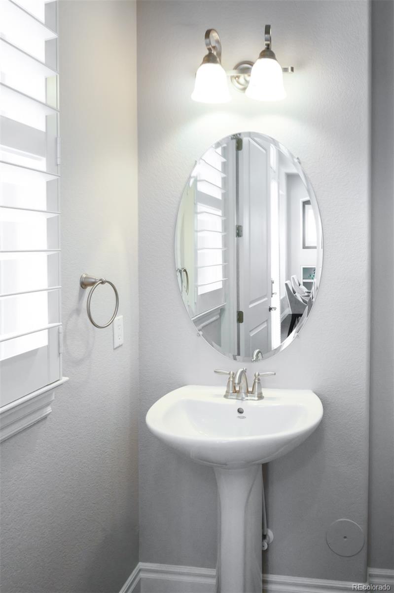 10140 RidgeGate Circle Lone Tree, CO 80124 - Photo 16 of 32 a bathroom with a sink a mirror and a window