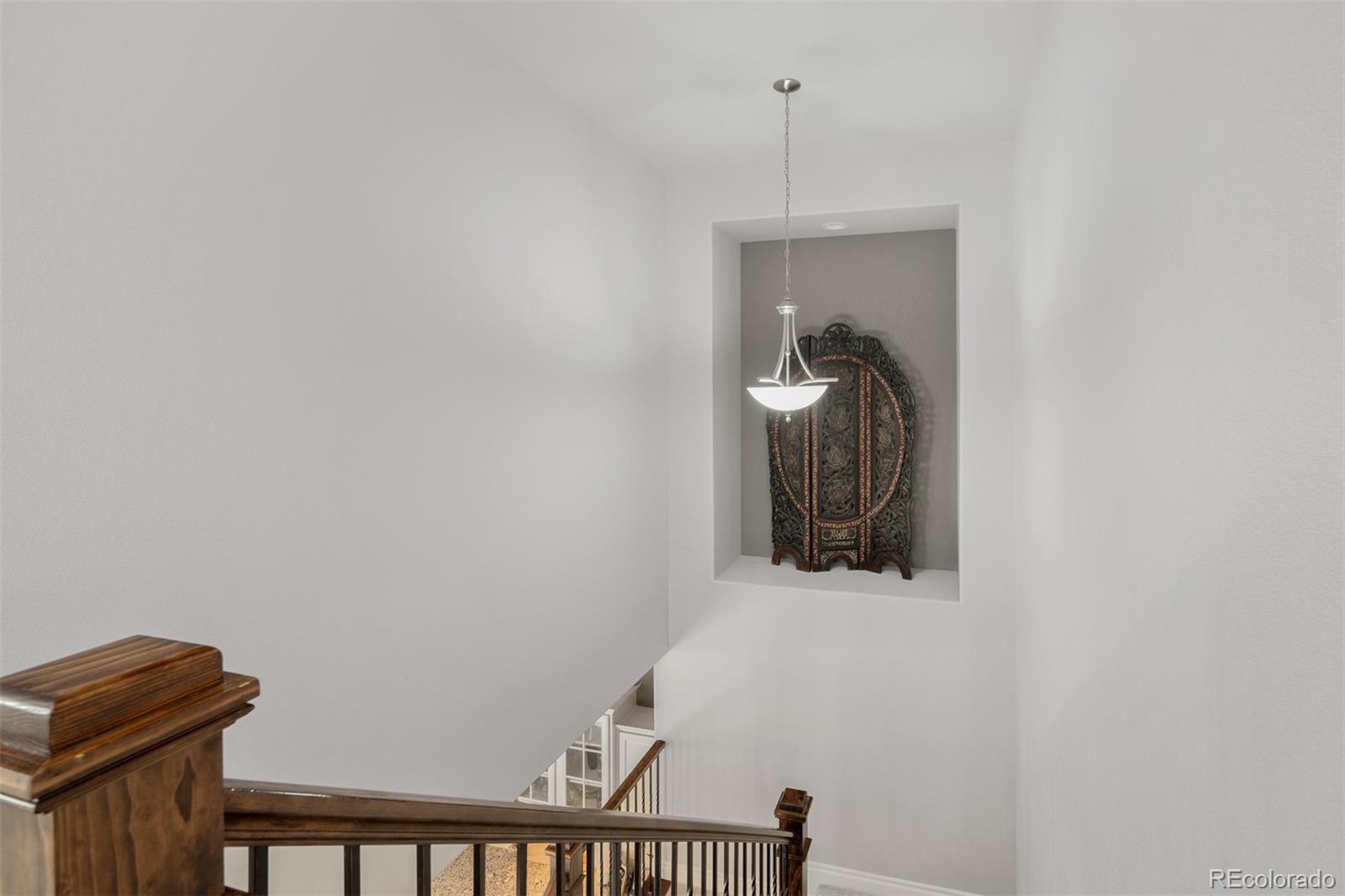 10140 RidgeGate Circle Lone Tree, CO 80124 - Photo 17 of 32 a view of a hallway with staircase