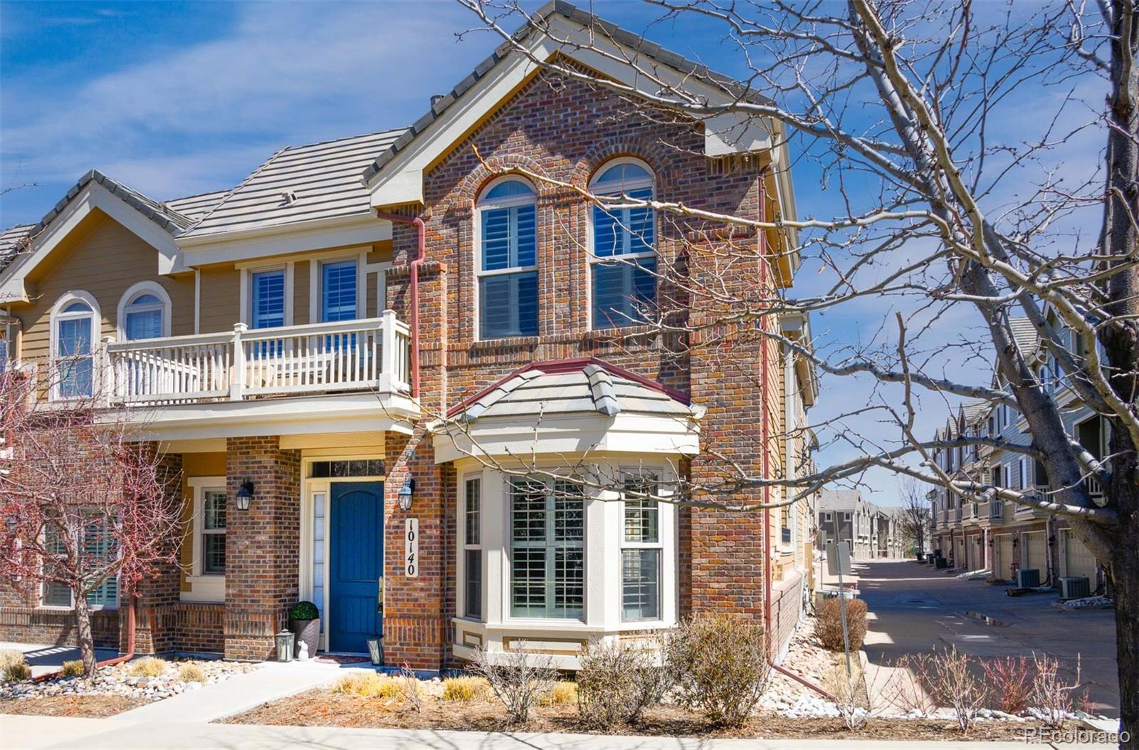 10140 RidgeGate Circle Lone Tree, CO 80124 - Photo 3 of 32 a front view of a residential apartment building with a yard