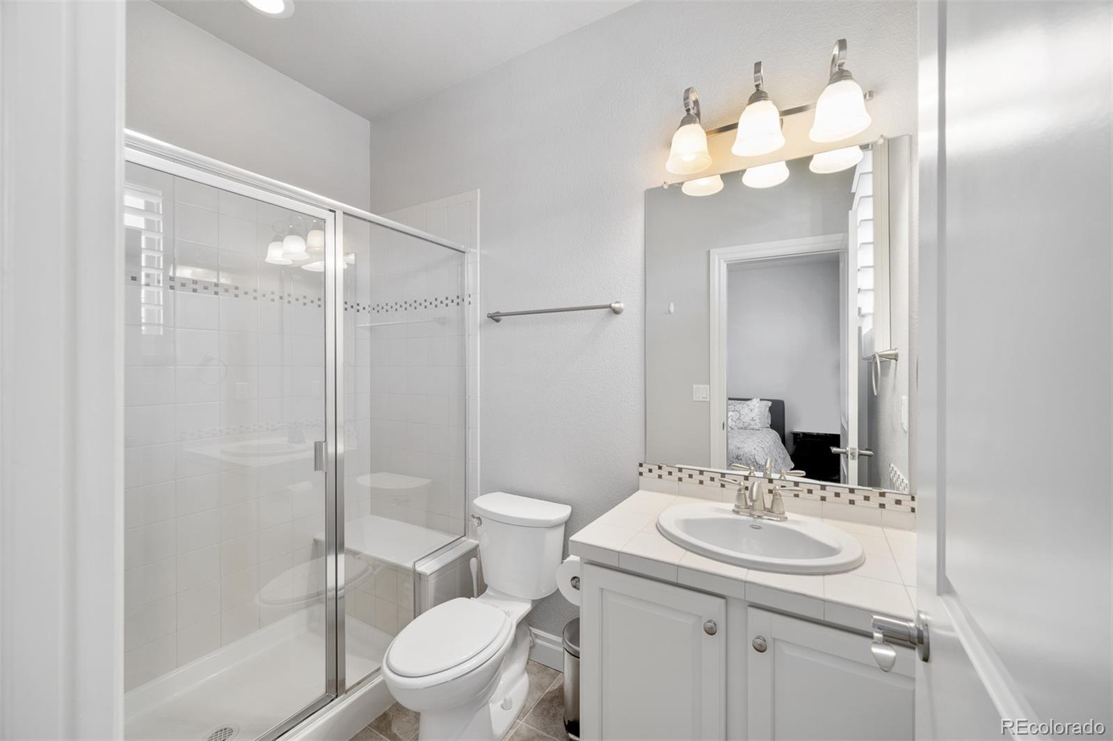 10140 RidgeGate Circle Lone Tree, CO 80124 - Photo 31 of 32 a bathroom with a sink toilet and shower