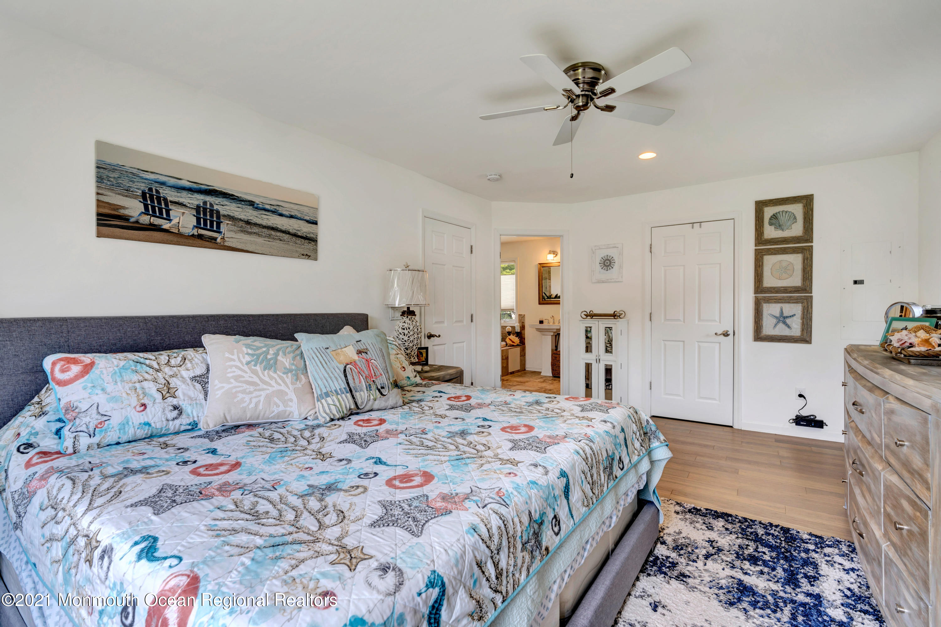 80 Port Road Brick, NJ 08723 - Photo 8 of 29 a bedroom with a large bed and a chandelier