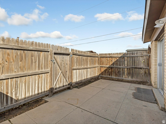 1478 North 75 West, Unit AD Sunset, UT 84015 - Photo 26 of 26 Fenced backyard featuring a patio area and a gate