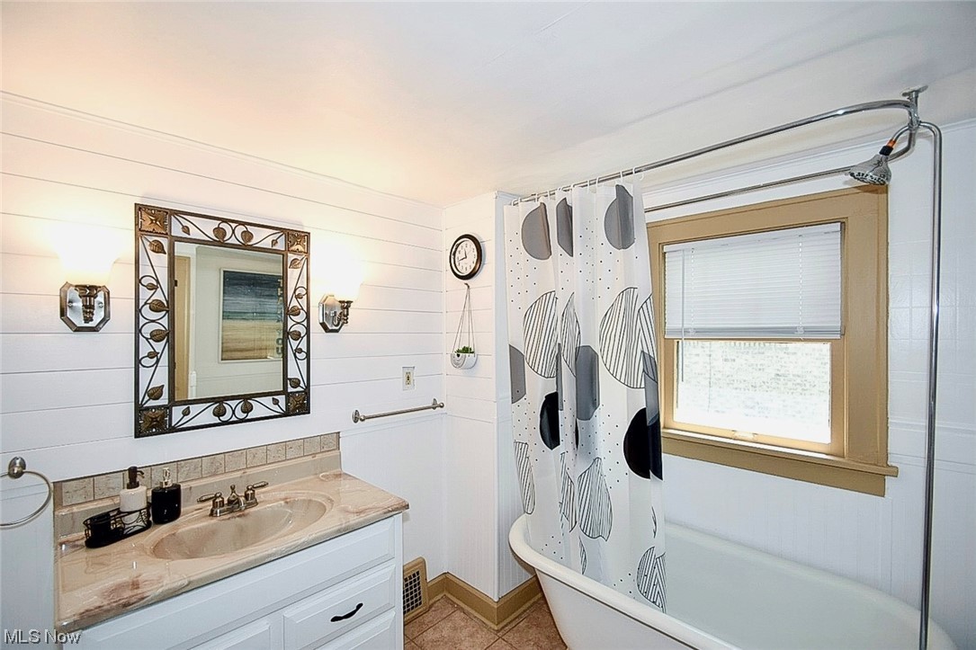 1233 Ridge Road Northwest Canton, OH 44703 - Photo 19 of 24 Bathroom with vanity, mirror, and light tile floors