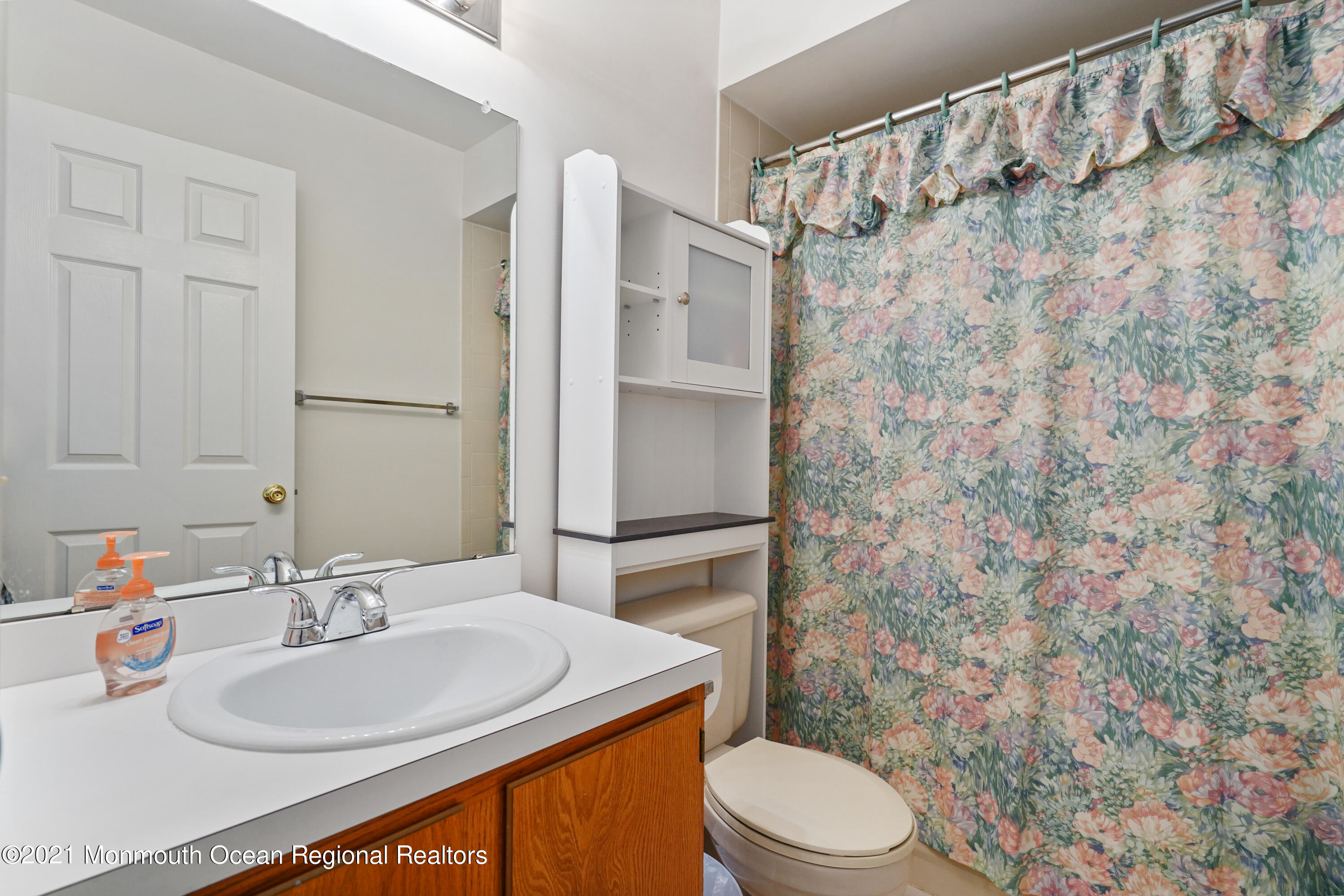 44 Racquet Road Wall, NJ 07719 - Photo 12 of 21 a bathroom with a sink a toilet and shower curtain