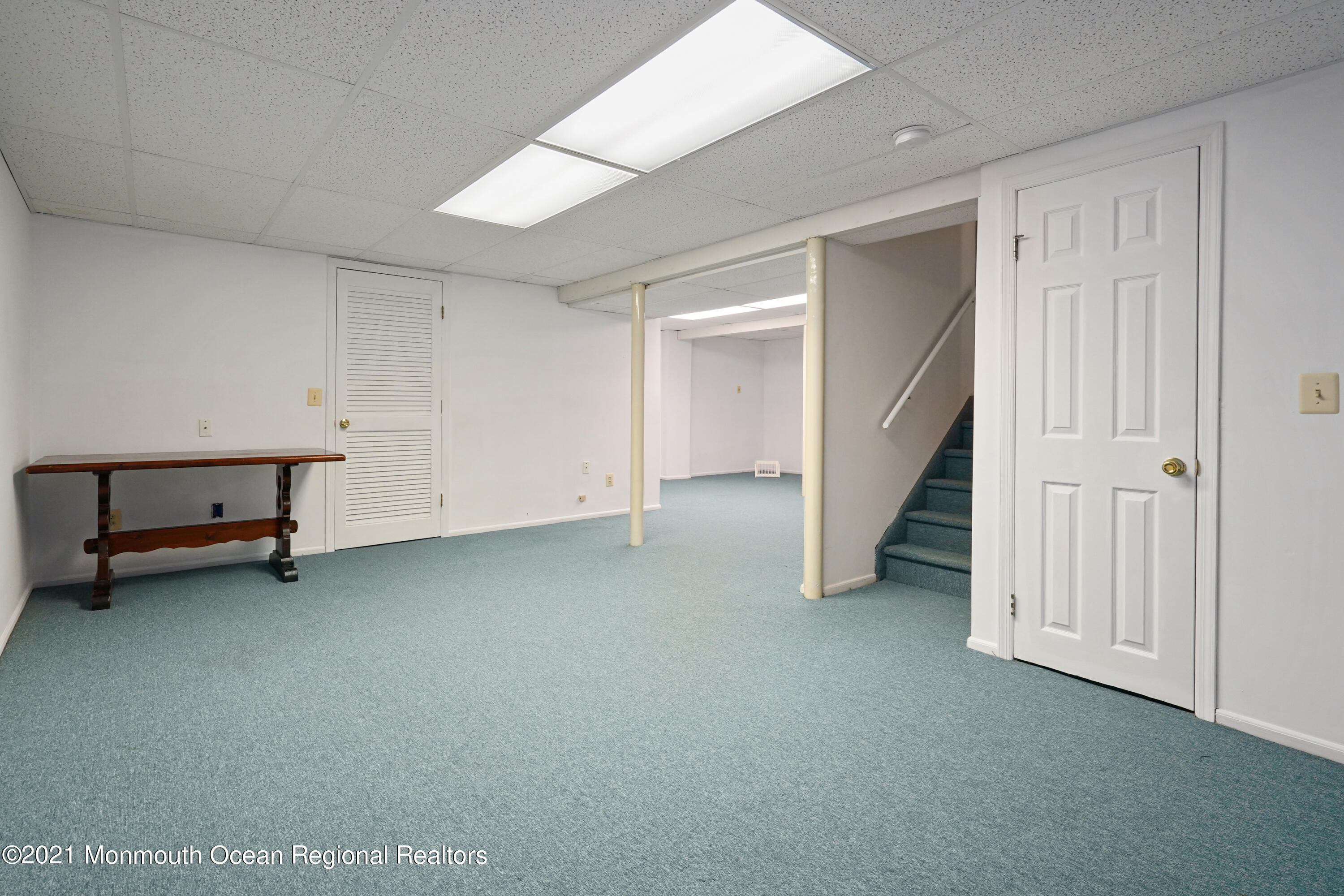 44 Racquet Road Wall, NJ 07719 - Photo 15 of 21 an empty room with a bench and white walls